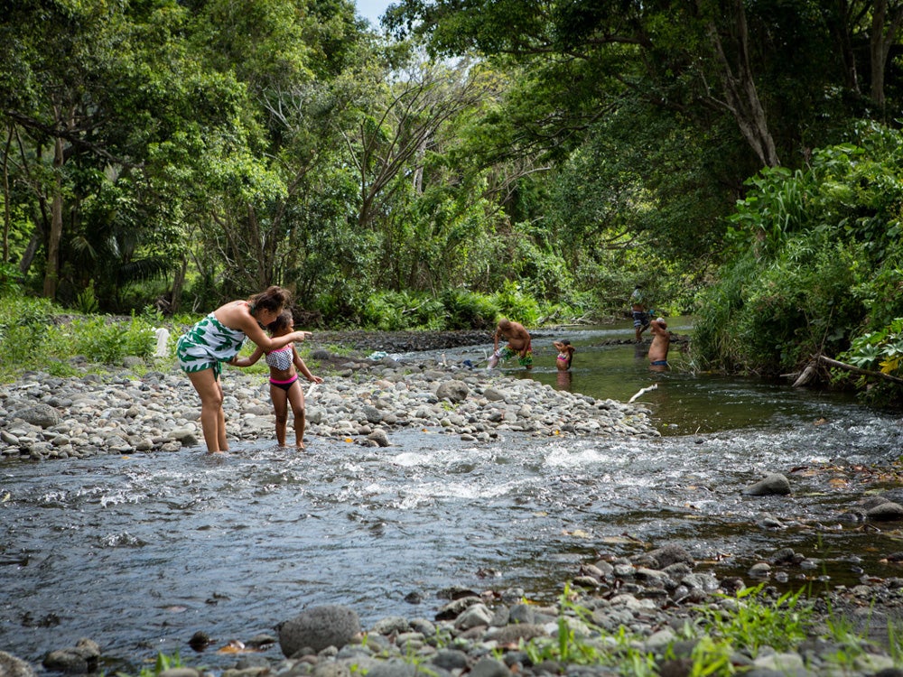 Mock Chew family members cool off in one the streams flowing through Waipi'o Valley