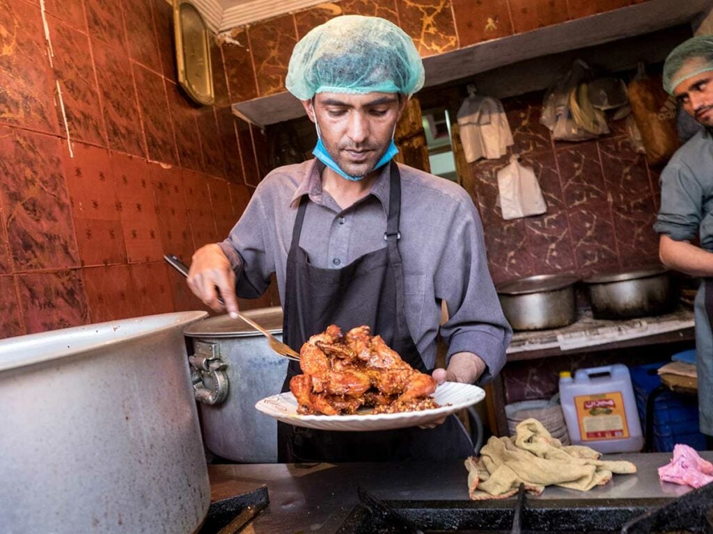 At Taj Mahal restaurant, whole chickens are coated in a proprietary spice rub before they're deep-fried to a crisp.
