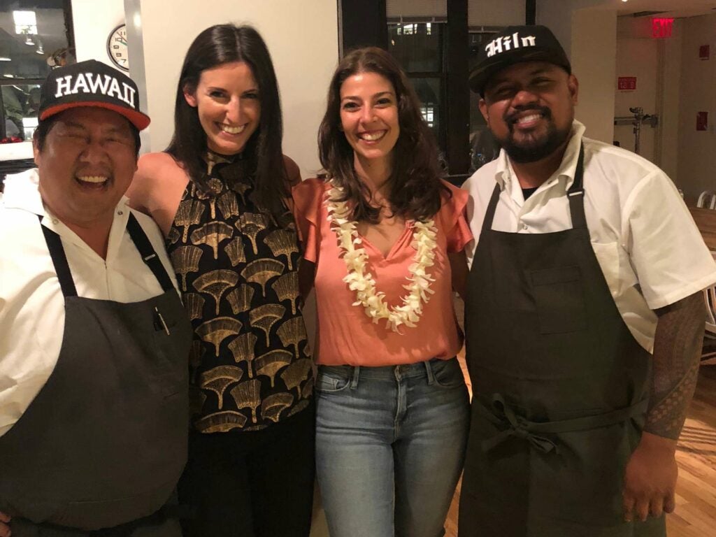 two women and the chefs at SAVEUR test kitchen supper