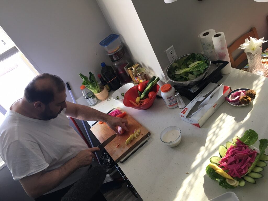 A Syrian refugee chef making breakfast of falafel