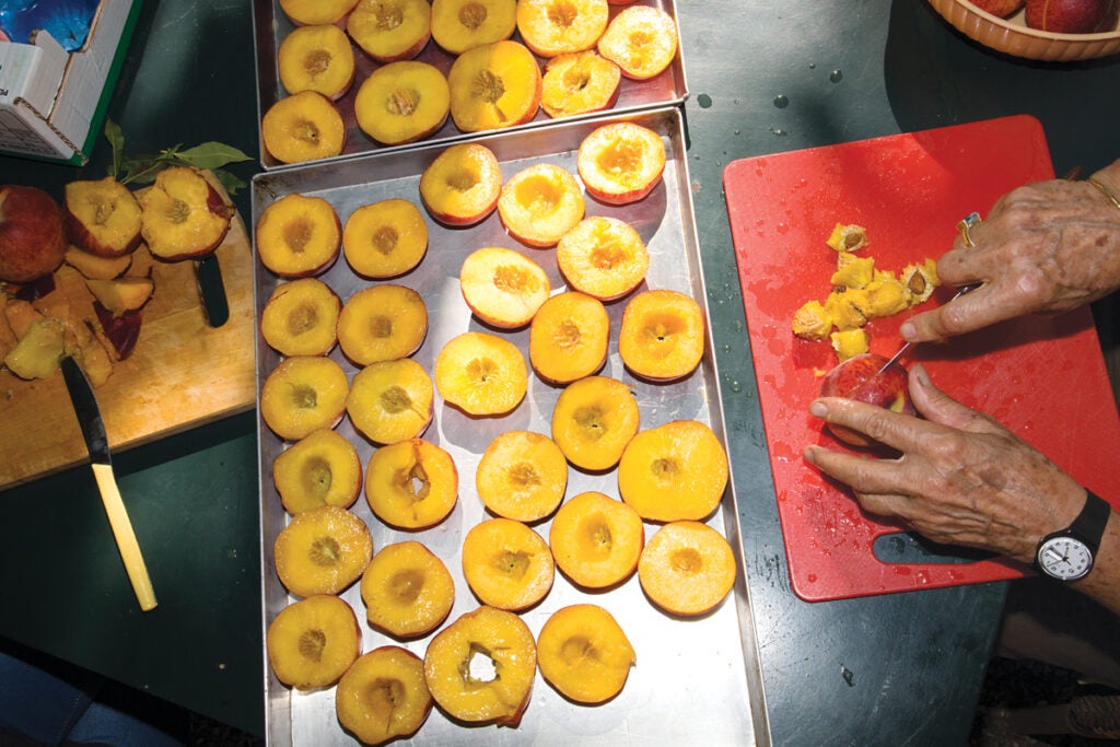 Peaches being prepped for an Amaretti tart