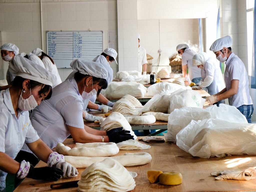 workers stacking erkuai in a factory