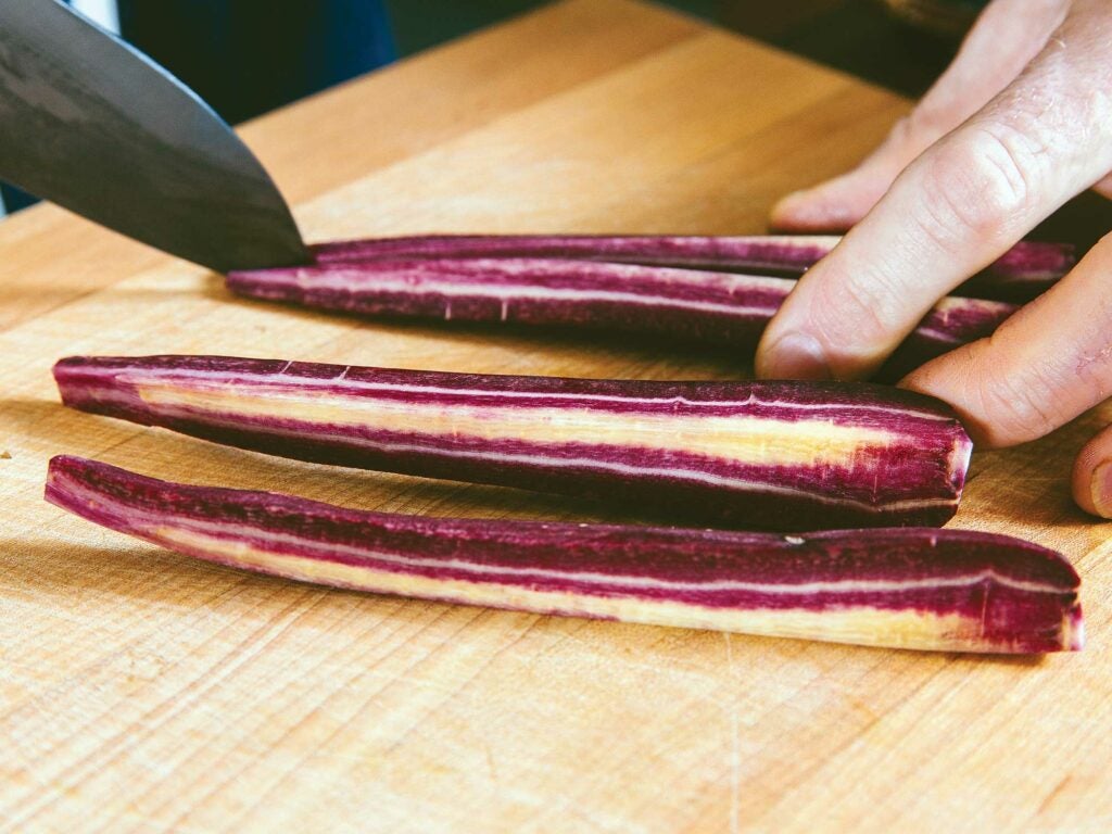 slicing purple carrots