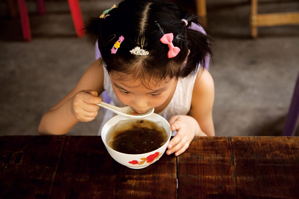 child eating spicy soup