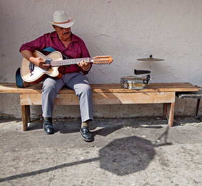 A man playing the guitar in Boyle Heights