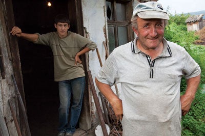 Gyuri Barabas, the local blacksmith in front of his workshop with his apprentice, in the village of Miklosvar