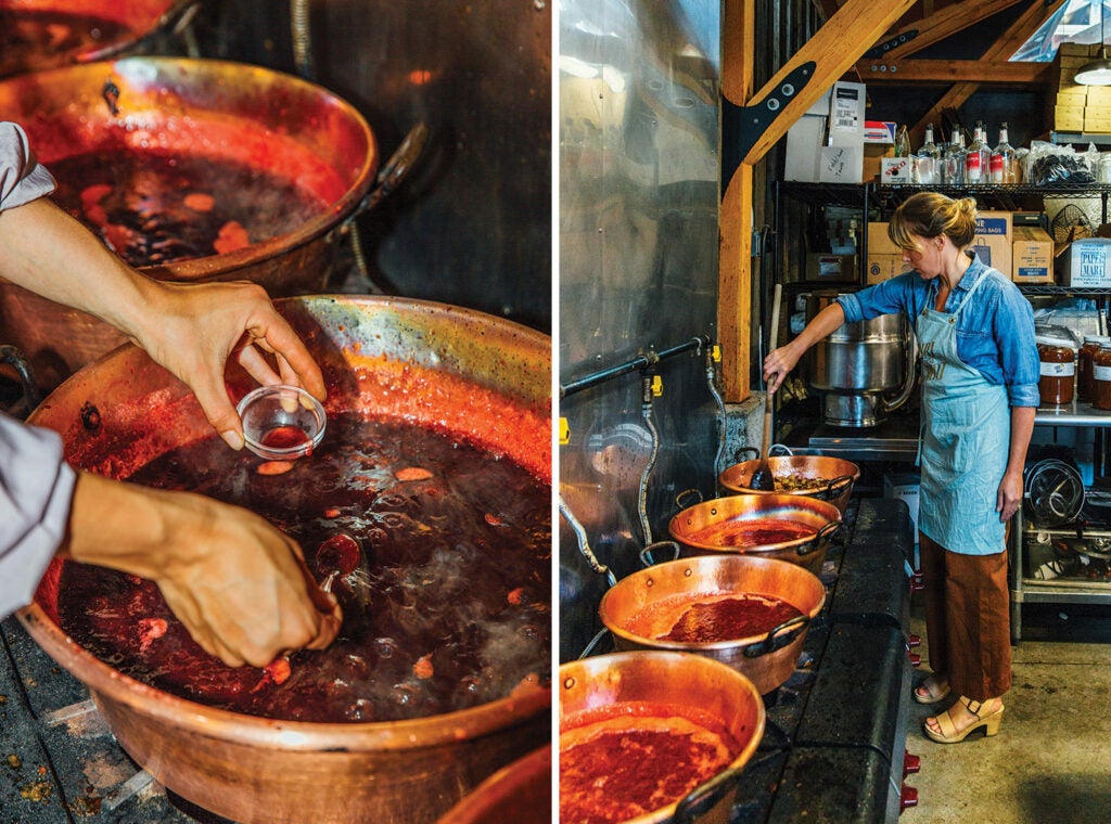Audra Lawlor stirring fruit in seasoned copper pots