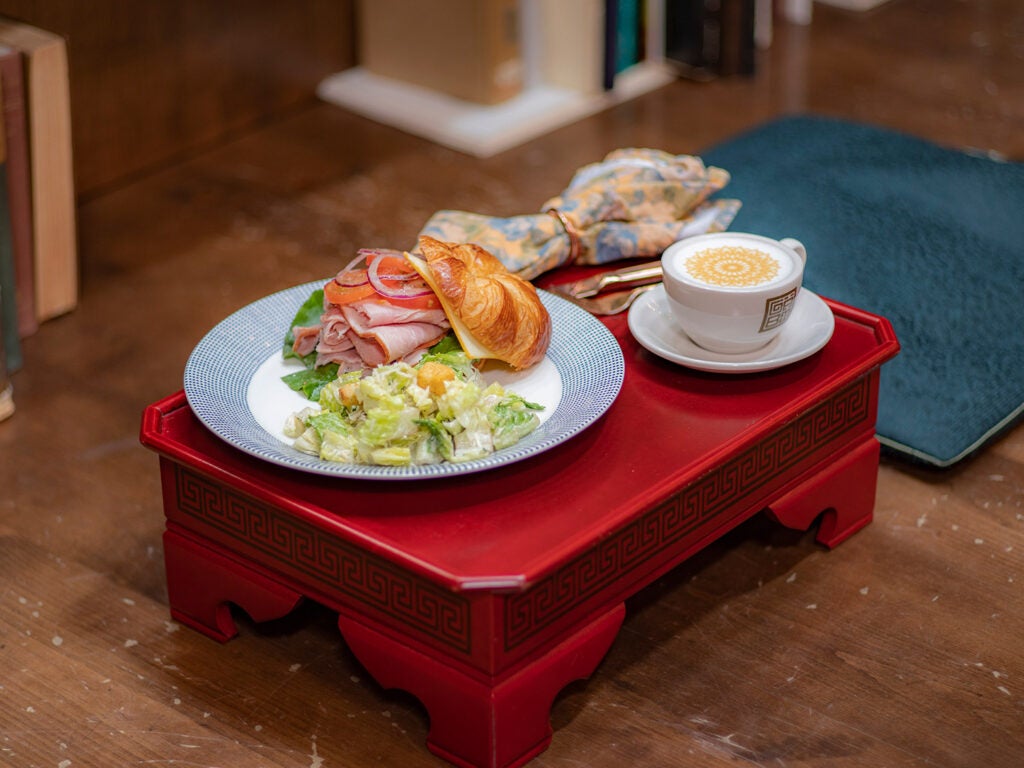 plated sandwich on red stool