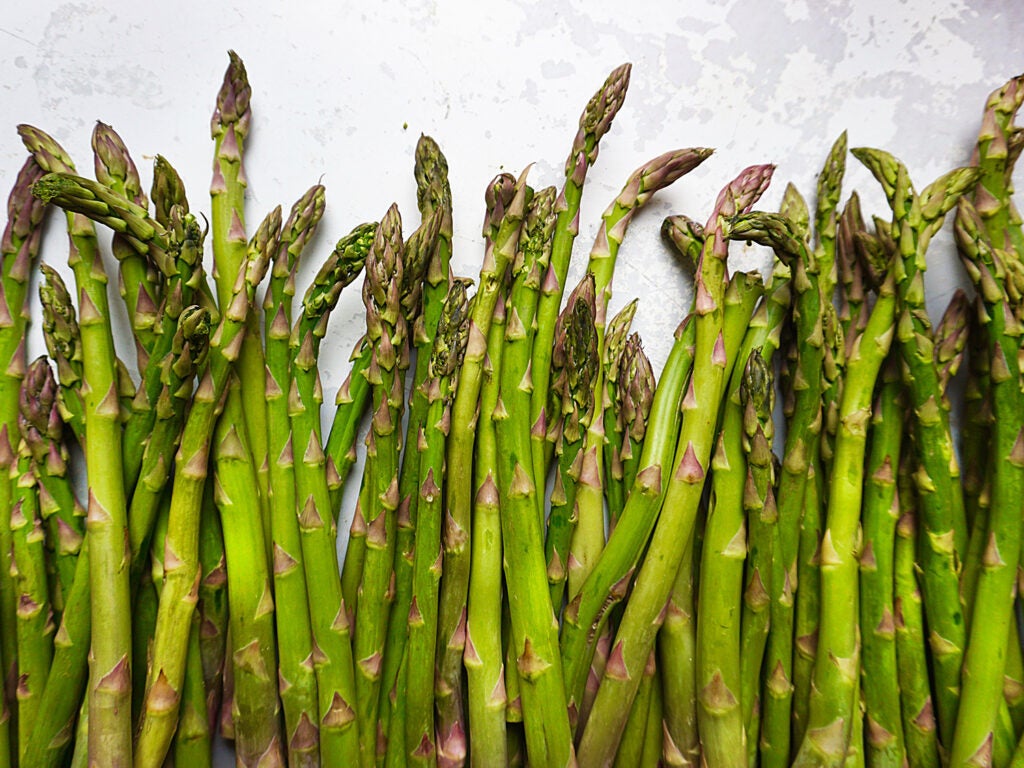 raw asparagus on white countertop