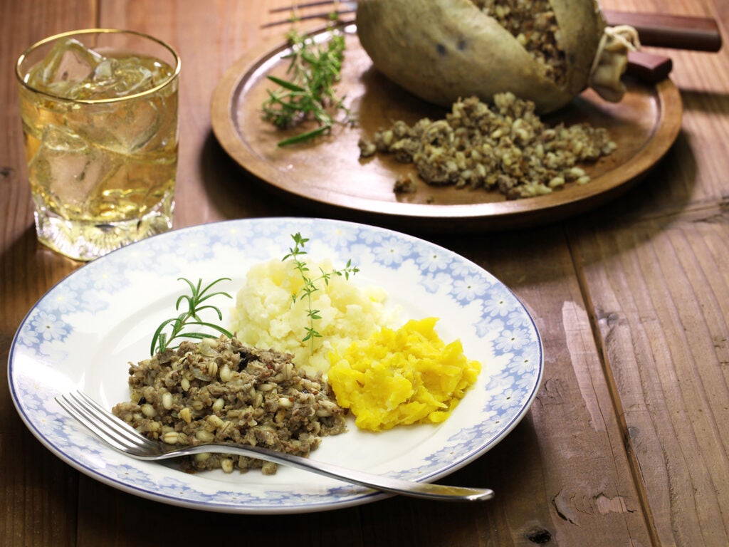 Haggis and sides on plate with drink