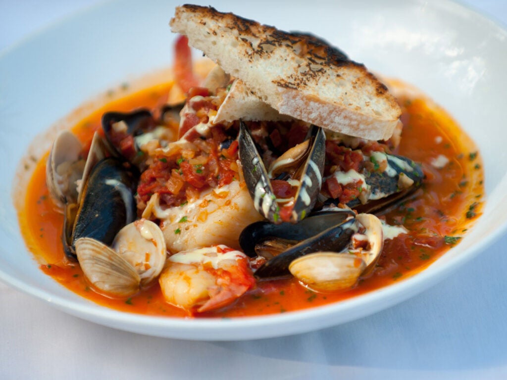 Mussels, shrimp and scallops in fish stew.
