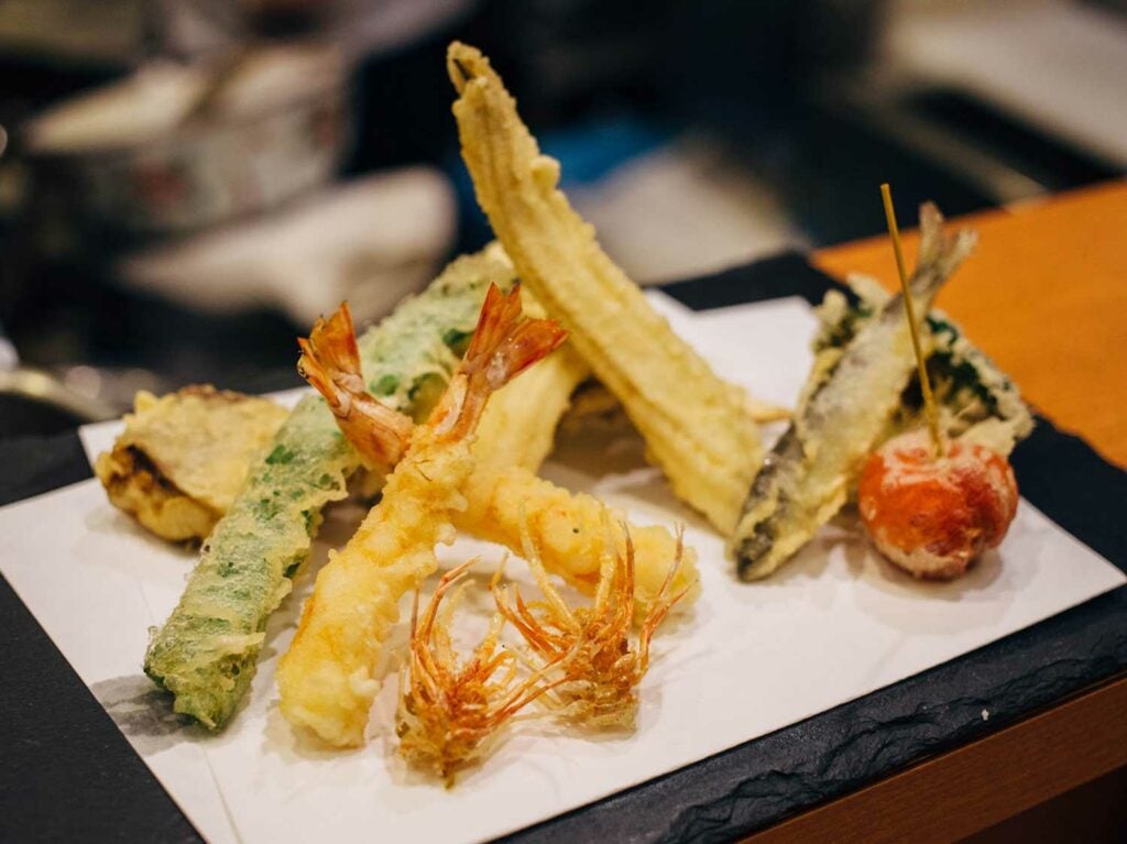 Abe Honten’s early summer tempura includes ayu (sweetfish), cherry tomato, flat beans, and baby corn.