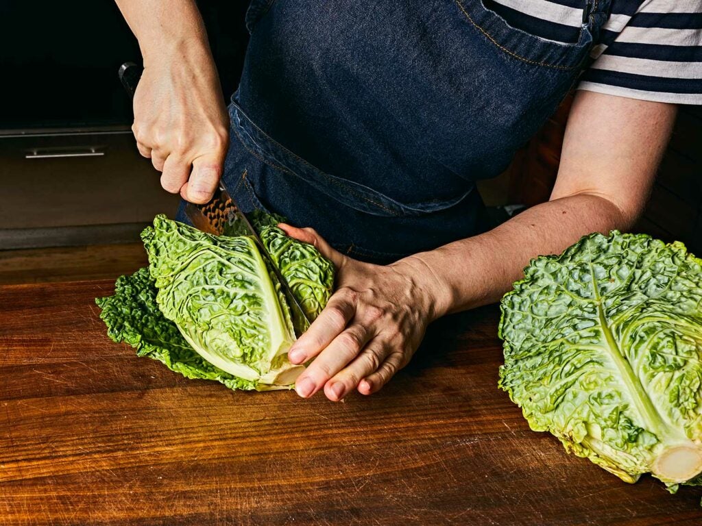 Cutting savoy cabbage into quarters.