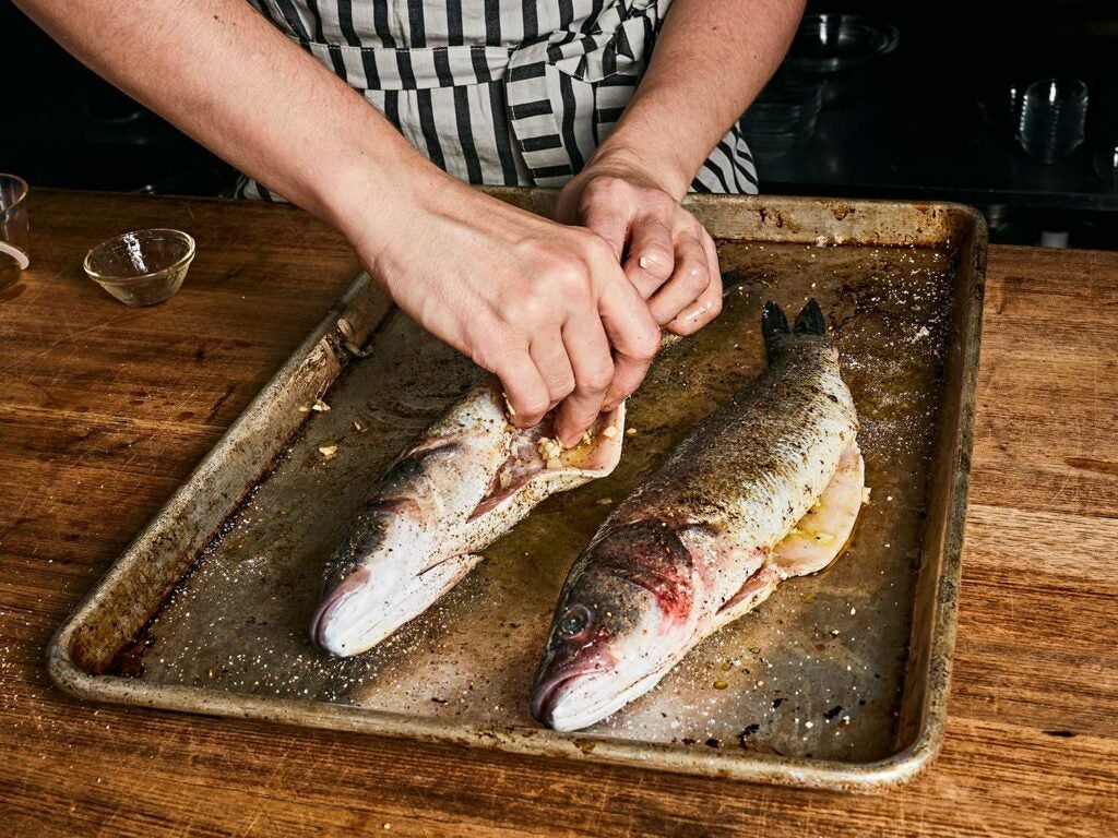 Patting fish dry and drizzling liberally with olive oil or clarified butter.