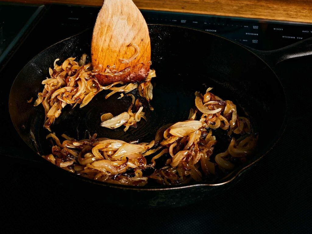 Caramelizing onions in a cast-iron skillet.
