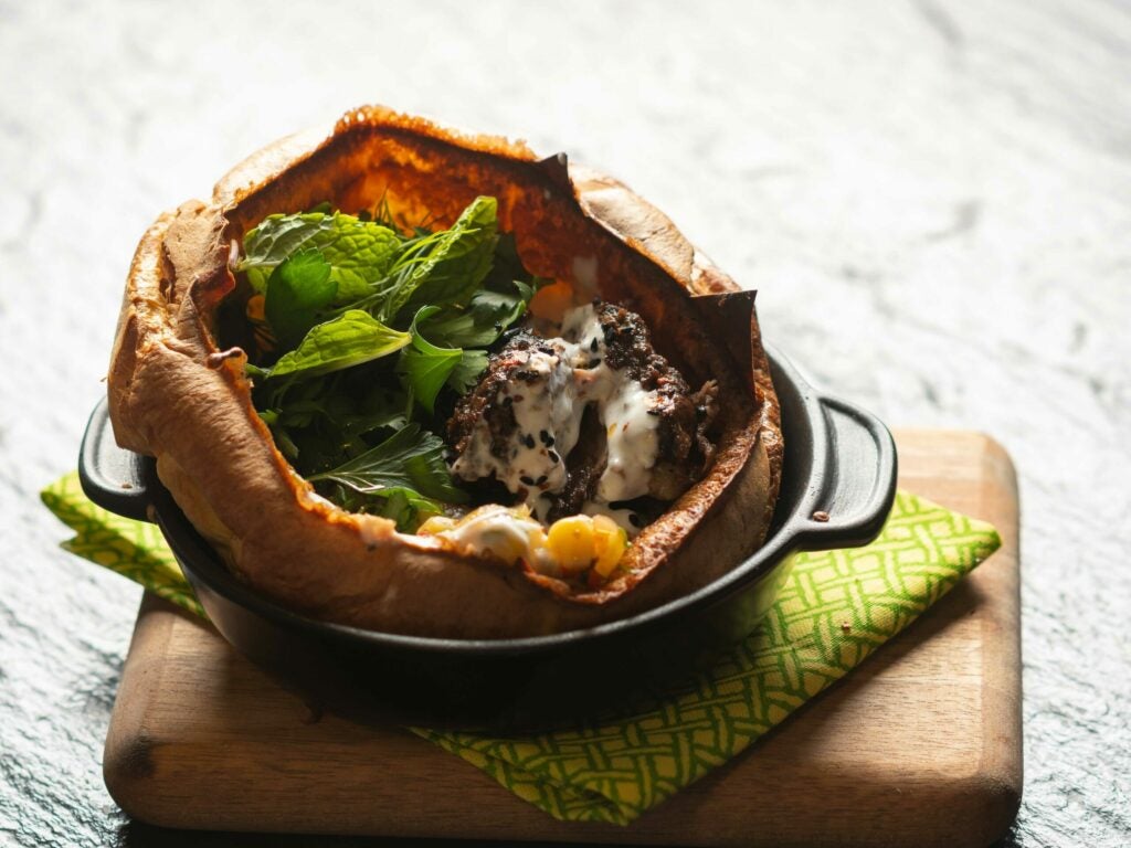 Chef Barwick’s Turkish smoked and roasted lamb shoulder presented in a bowl-shaped, popover-like feta-and- lamb-fat borek, along with a corn ezme and plenty of fresh mint.