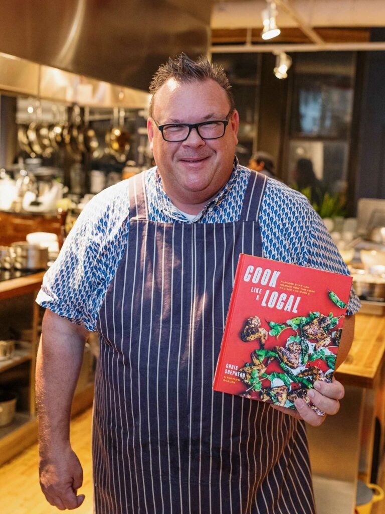 Chef Chris Shepherd with his new book, Cook Like a Local, in the SAVEUR test kitchen.