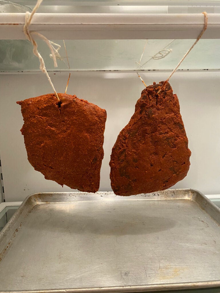 spiced meat hanging in a fridge