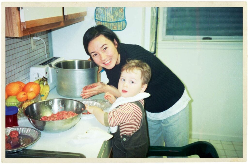 Mother and son making meatballs.